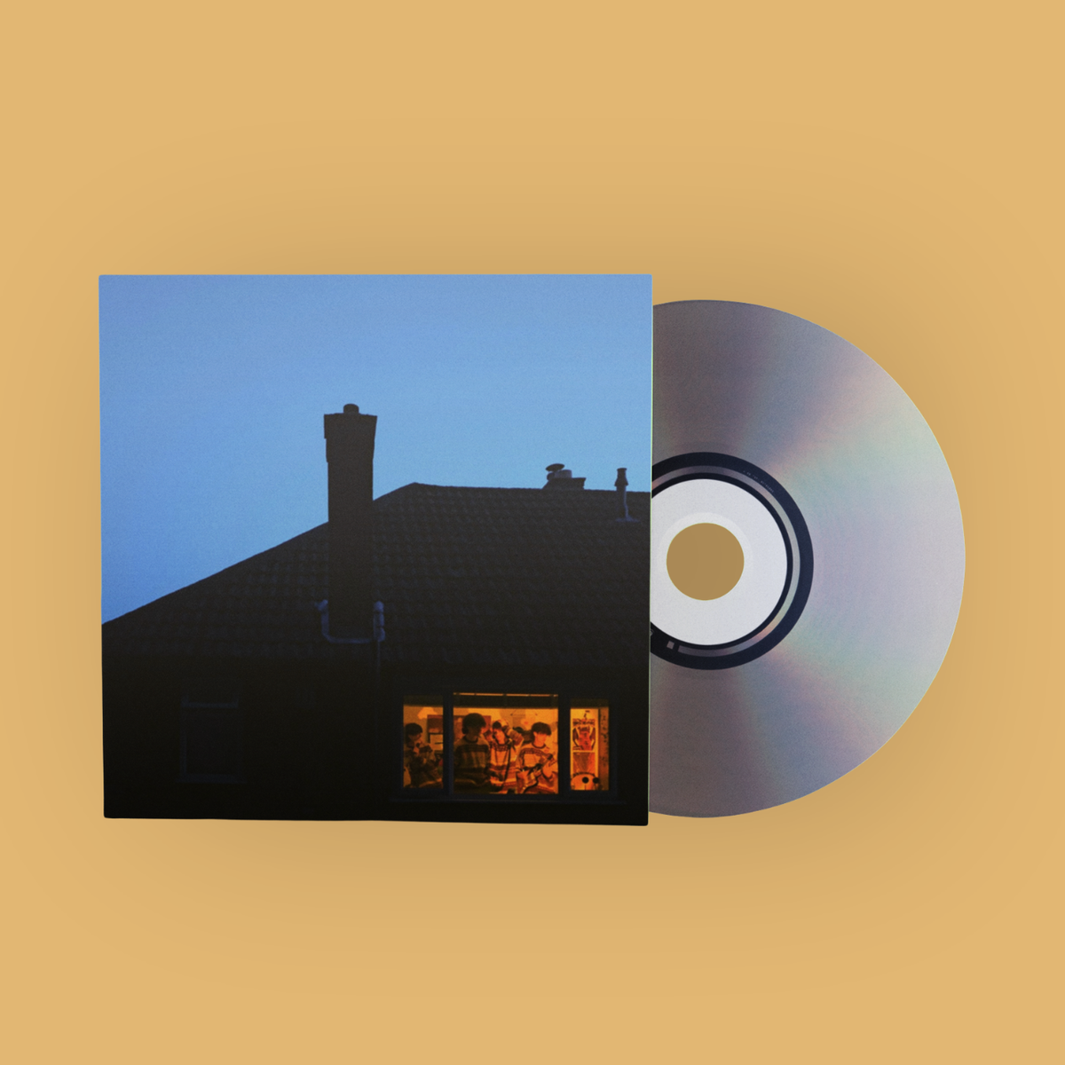 A CD album with its square paper sleeve in front of the disc. The sleeve shows a dark house silhouette against a blue sky, with a small warm-toned window at the bottom.